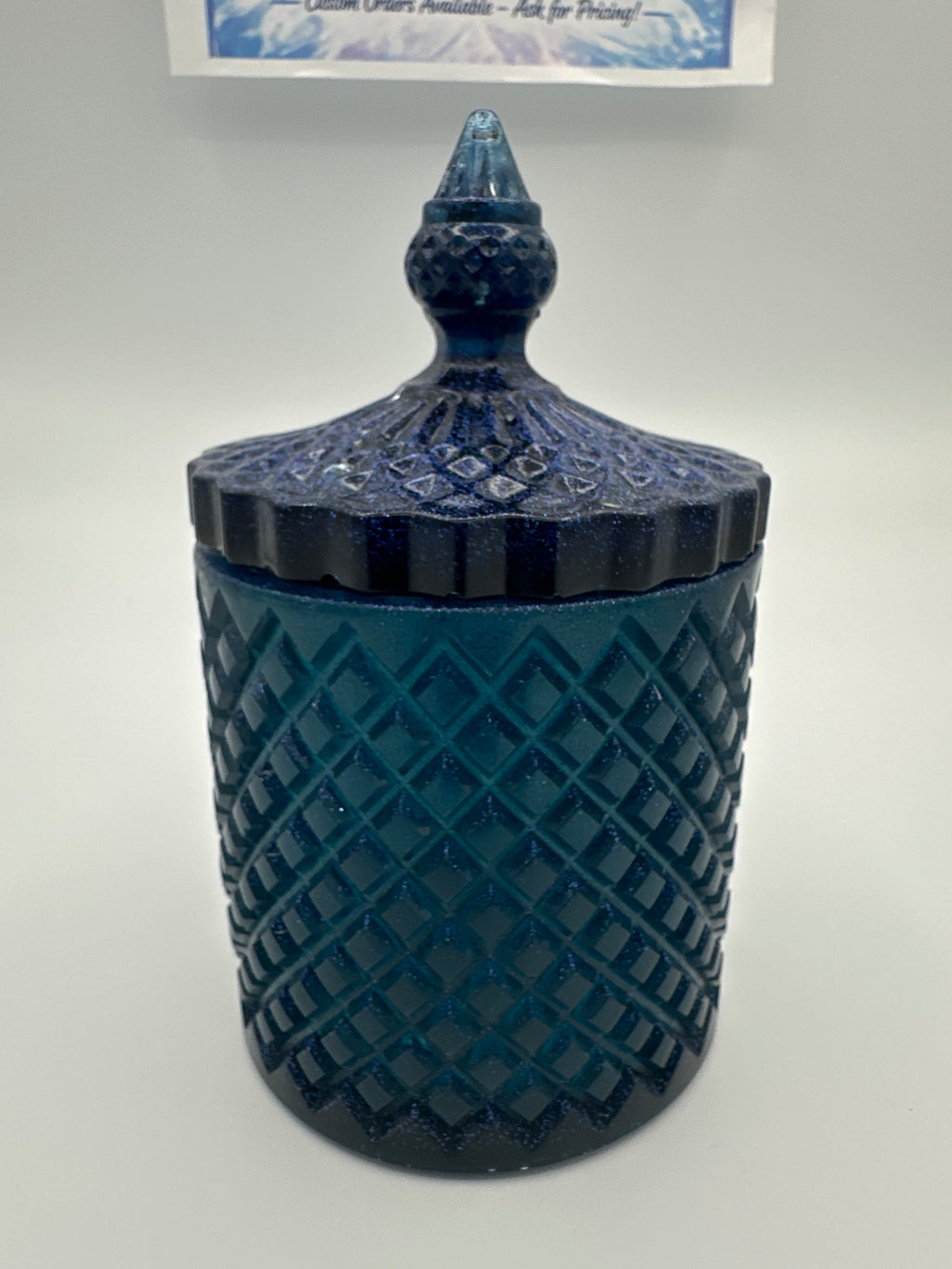 Container with lid 6 inches high/color is deep blue with sparkle/weight 9.0 ounces/item number 83