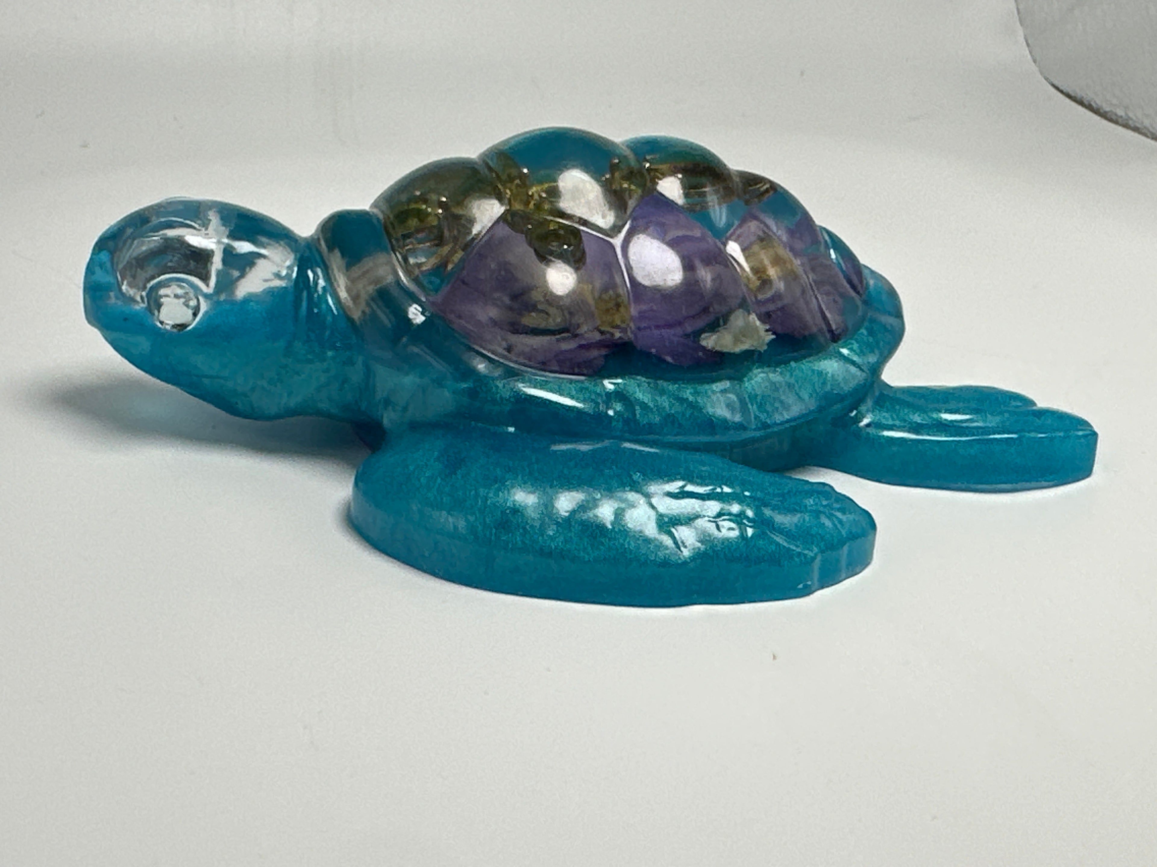 Sea Turtle 5 inch Aqua- Blue floral, Green jeweled cross. Created from epoxy. Turtle has faux diamond eyes. Item 311
