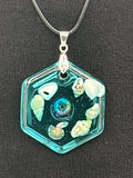Pendant / 1.5 inch /teal glitter/seashell iridescent pearl center/item 3

measures 1.5” by 1.5”